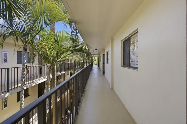 a view of staircase with railing and a chandelier