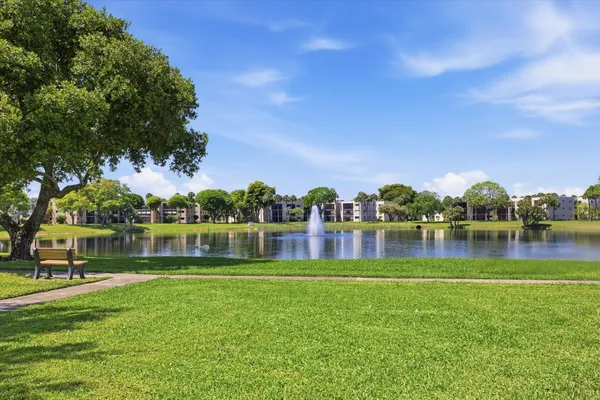 a view of a lake in front of house with a yard