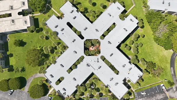 an aerial view of residential houses with outdoor space