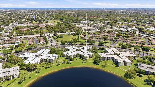 an aerial view of residential houses with outdoor space and trees