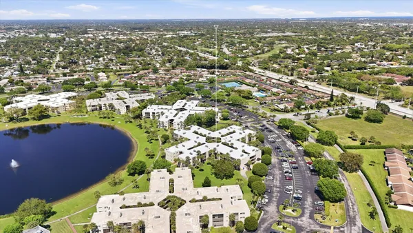 an aerial view of residential houses with outdoor space and trees