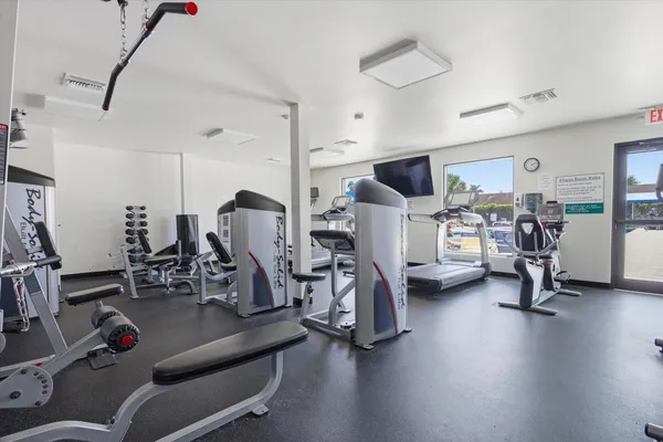 a gym room with lots of gym equipment