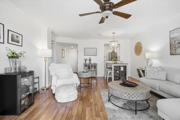 a living room with furniture a rug and a chandelier