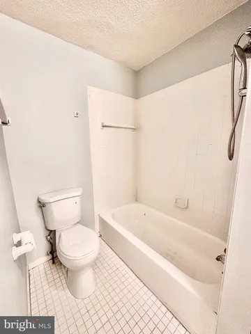 a bathroom with a toilet and a bathtub