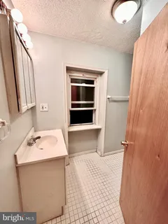 a bathroom with a sink vanity and mirror