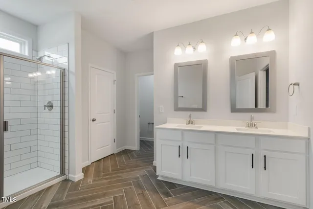 a bathroom with a granite countertop sink toilet and mirror