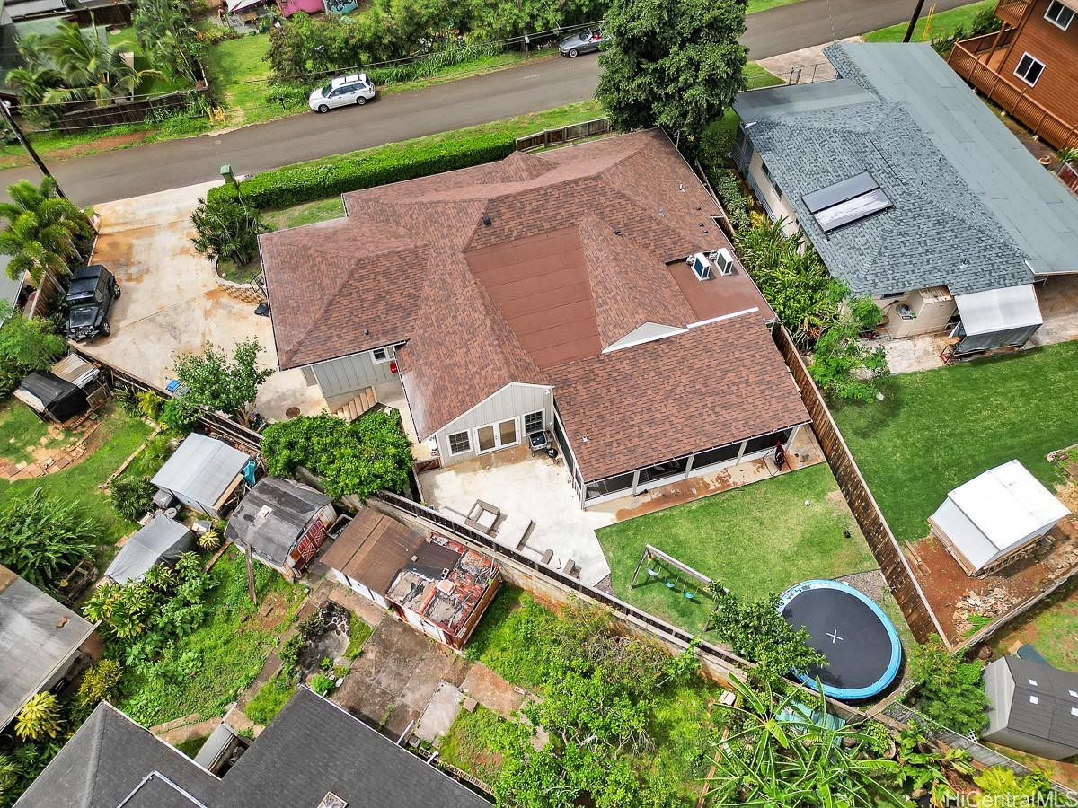an aerial view of a house with a yard and lake view