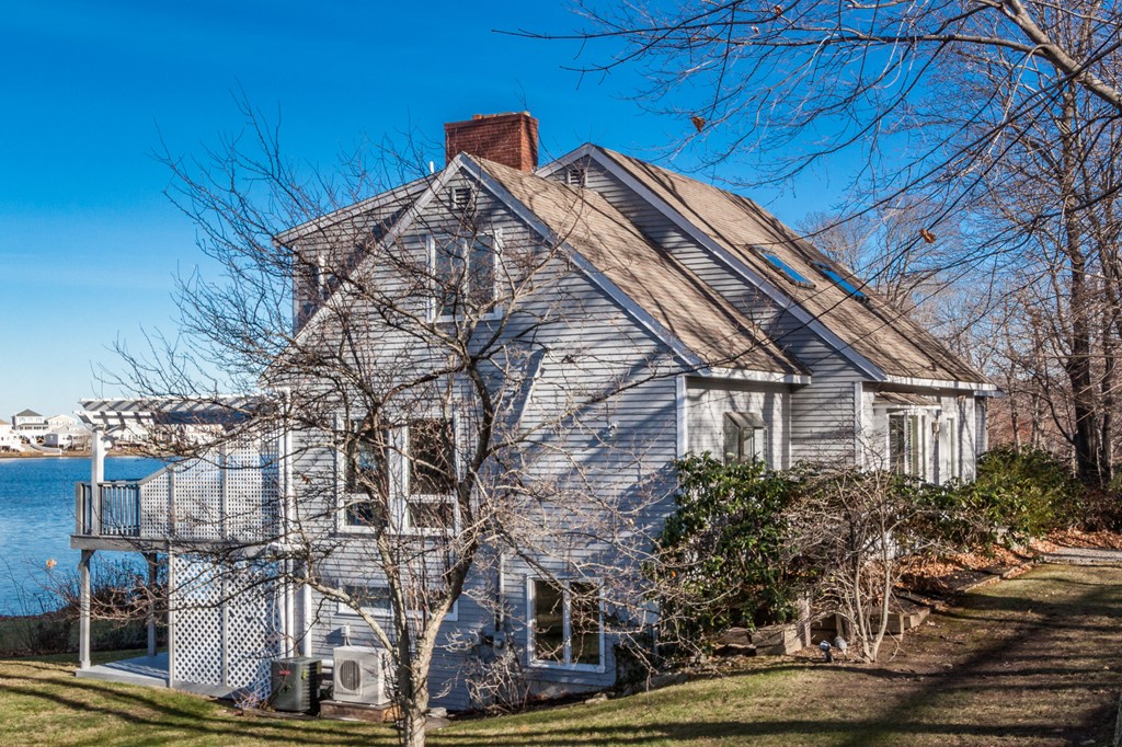 a view of a house with a wooden fence