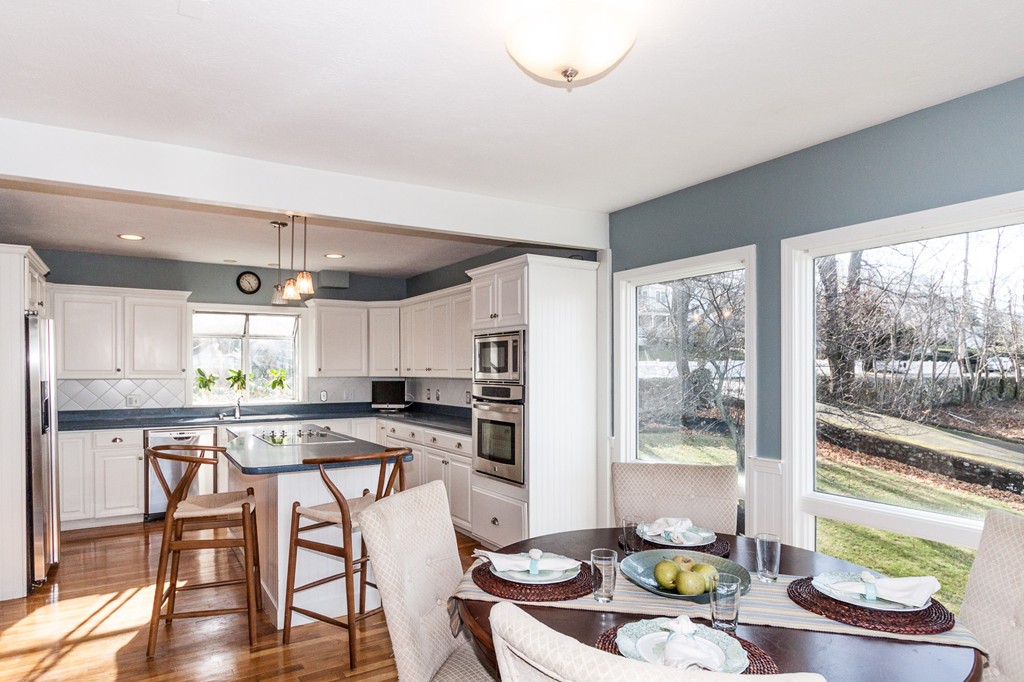 685 Jerusalem Road Cohasset, MA 02025 - Photo 14 of 29 a kitchen with stainless steel appliances wooden floor dining table and chairs