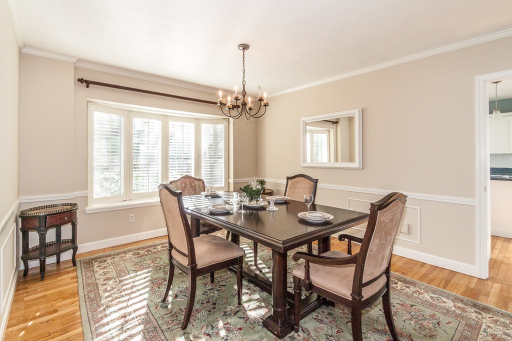 685 Jerusalem Road Cohasset, MA 02025 - Photo 15 of 29 a dining room with furniture a chandelier and wooden floor