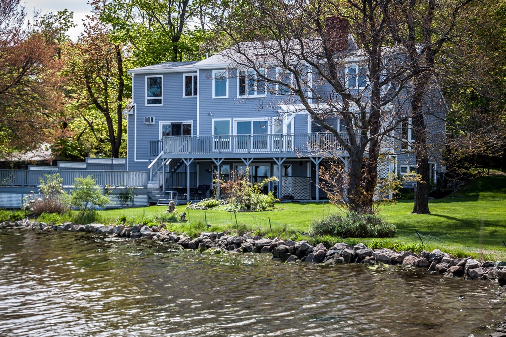 685 Jerusalem Road Cohasset, MA 02025 - Photo 2 of 29 a front view of a house with a yard and a garden