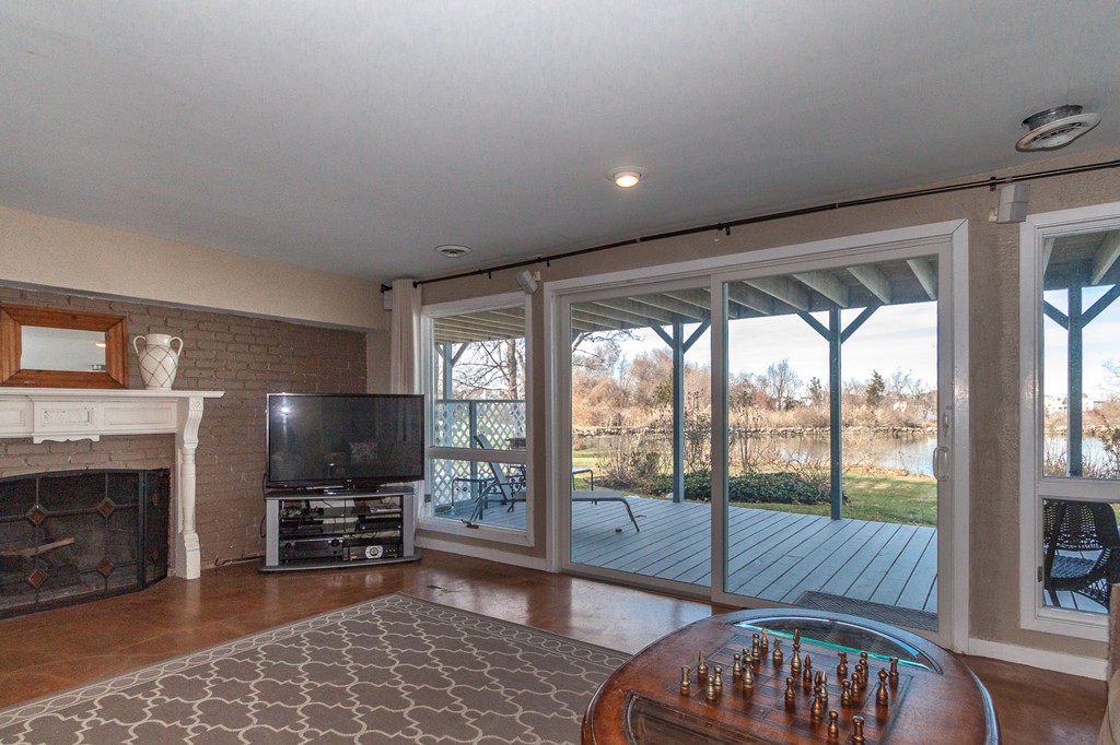 685 Jerusalem Road Cohasset, MA 02025 - Photo 25 of 29 a living room with furniture a flat screen tv and a fireplace