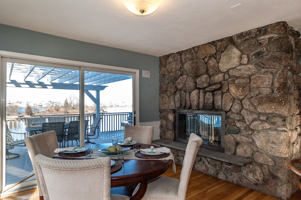 685 Jerusalem Road Cohasset, MA 02025 - Photo 10 of 29 a dining room with furniture and a floor to ceiling window