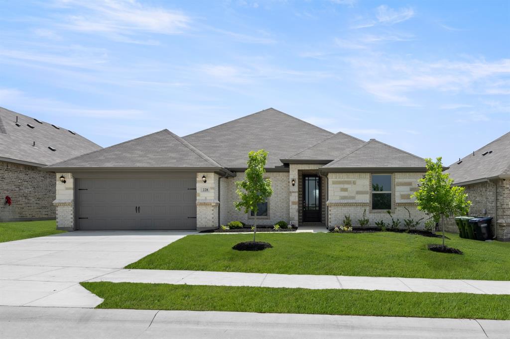 228 Shepards Street Godley, TX 76044 - Photo 1 of 27 a front view of a house with a garden and yard
