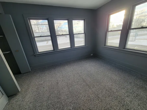 an empty room with a empty space and windows