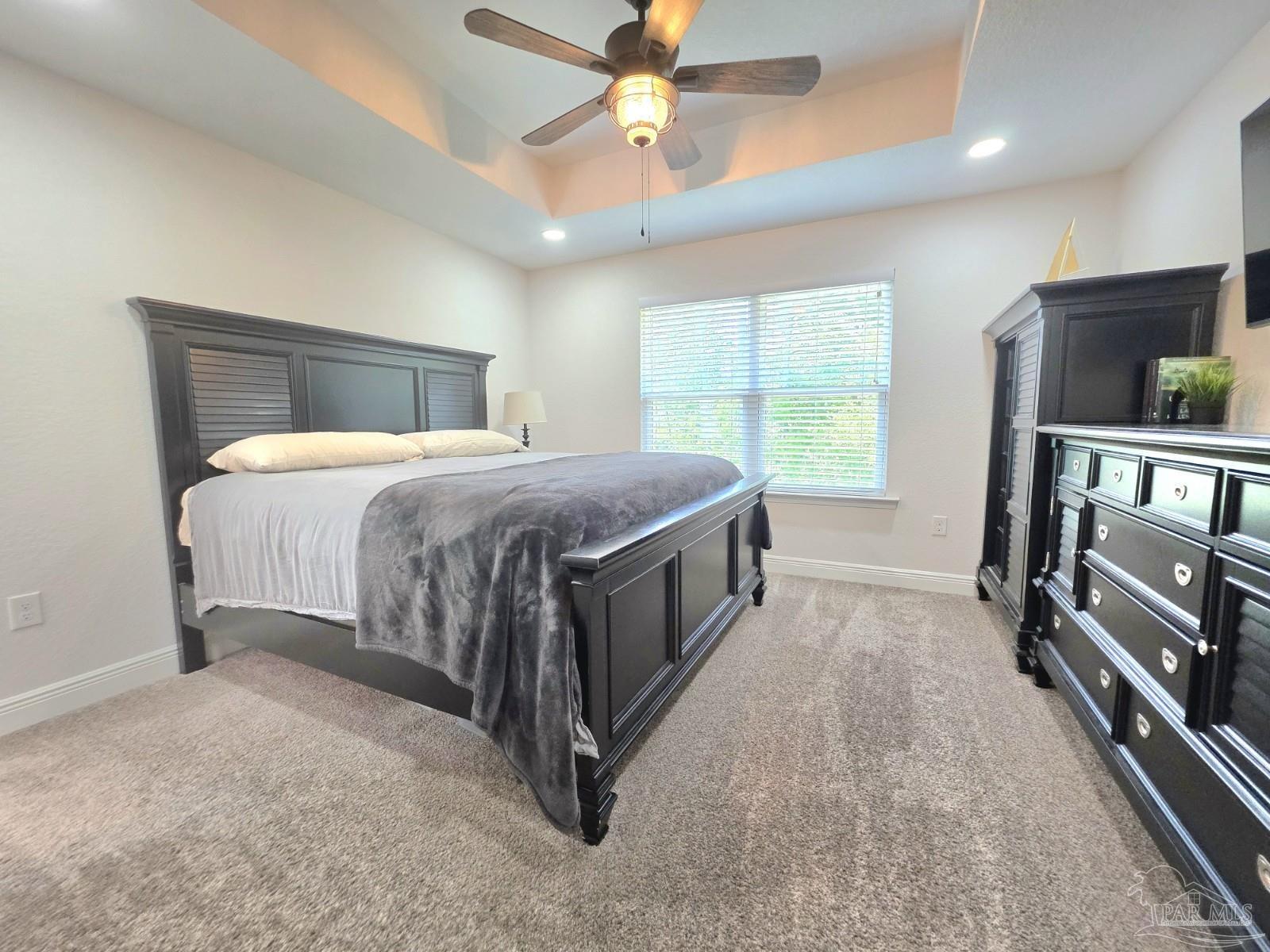 1307 Heron Inlet Pensacola, FL 32506 - Photo 13 of 35 a bedroom with a bed and a chandelier