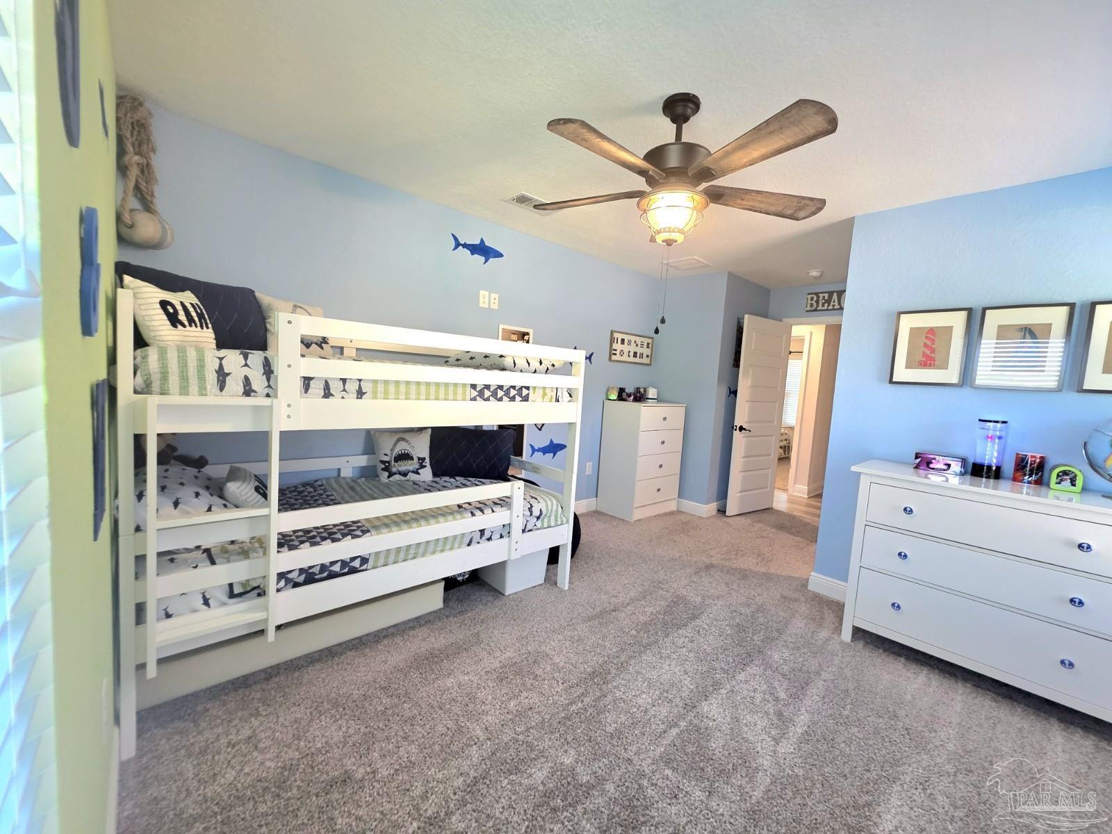 1307 Heron Inlet Pensacola, FL 32506 - Photo 20 of 35 a bed room with a bed and a ceiling fan