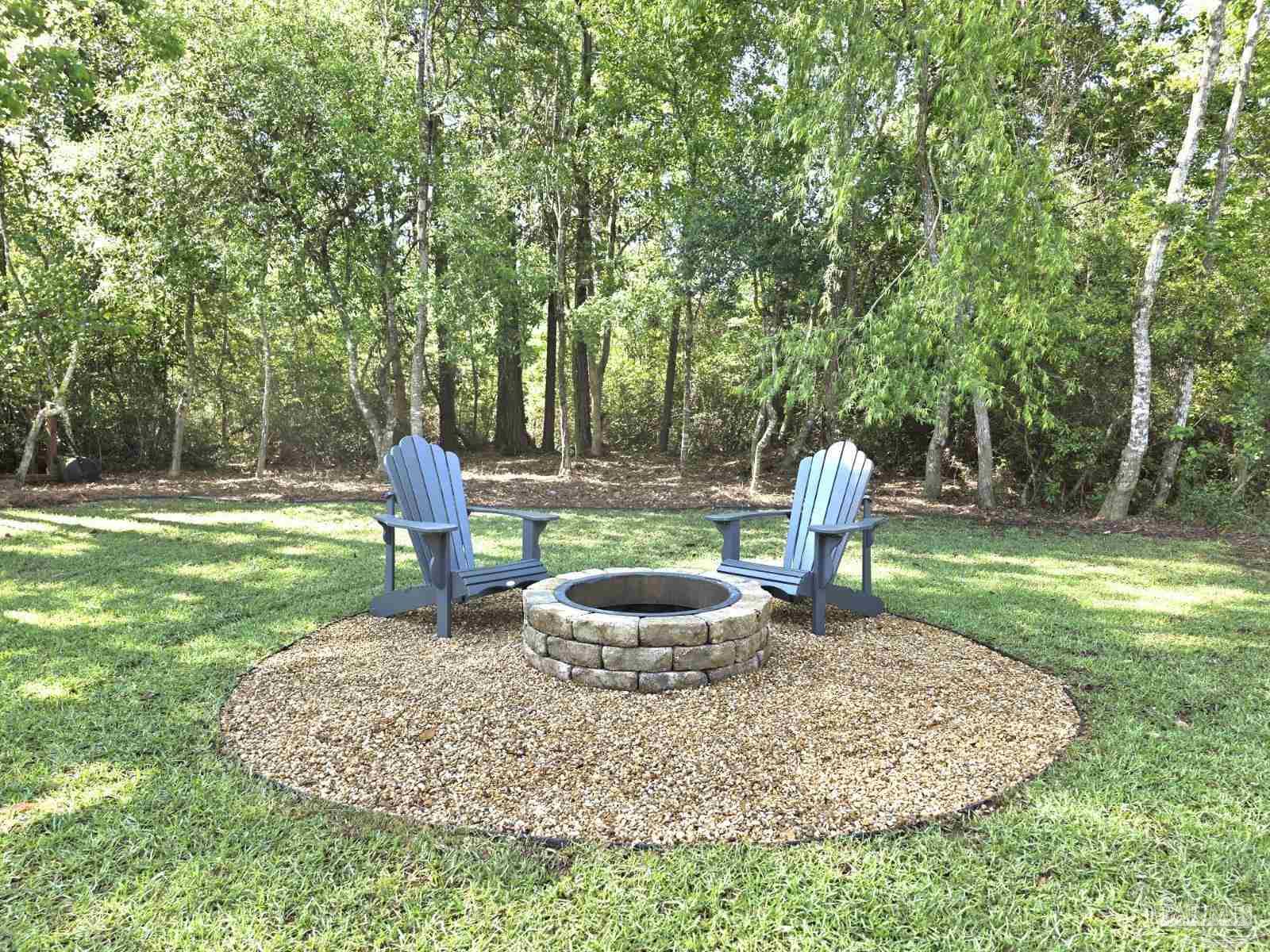 1307 Heron Inlet Pensacola, FL 32506 - Photo 30 of 35 a view of a backyard with table and chairs