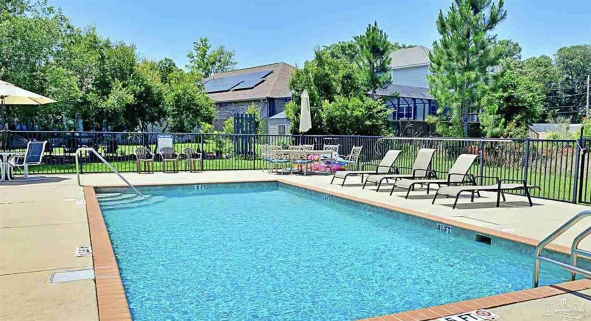 1307 Heron Inlet Pensacola, FL 32506 - Photo 34 of 35 a view of swimming pool with chairs and plants
