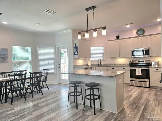a large kitchen with a table and chairs