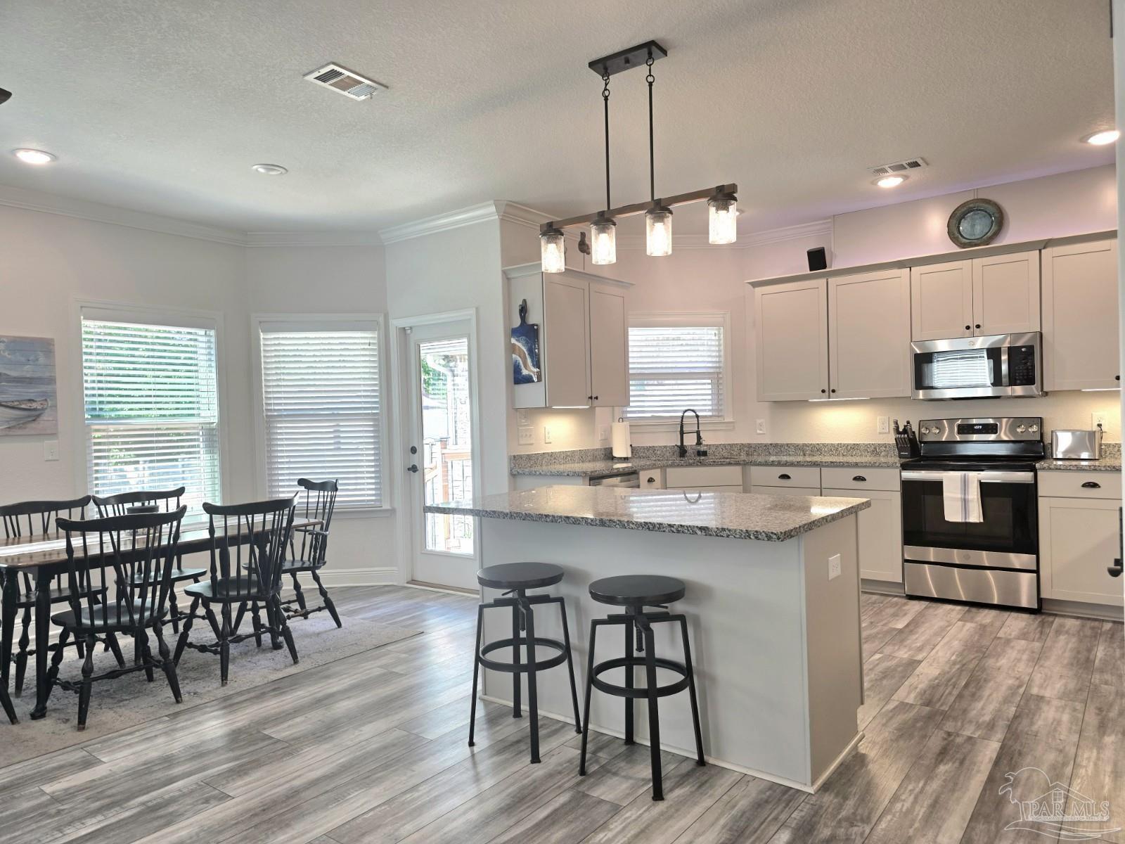 1307 Heron Inlet Pensacola, FL 32506 - Photo 5 of 35 a large kitchen with a table and chairs