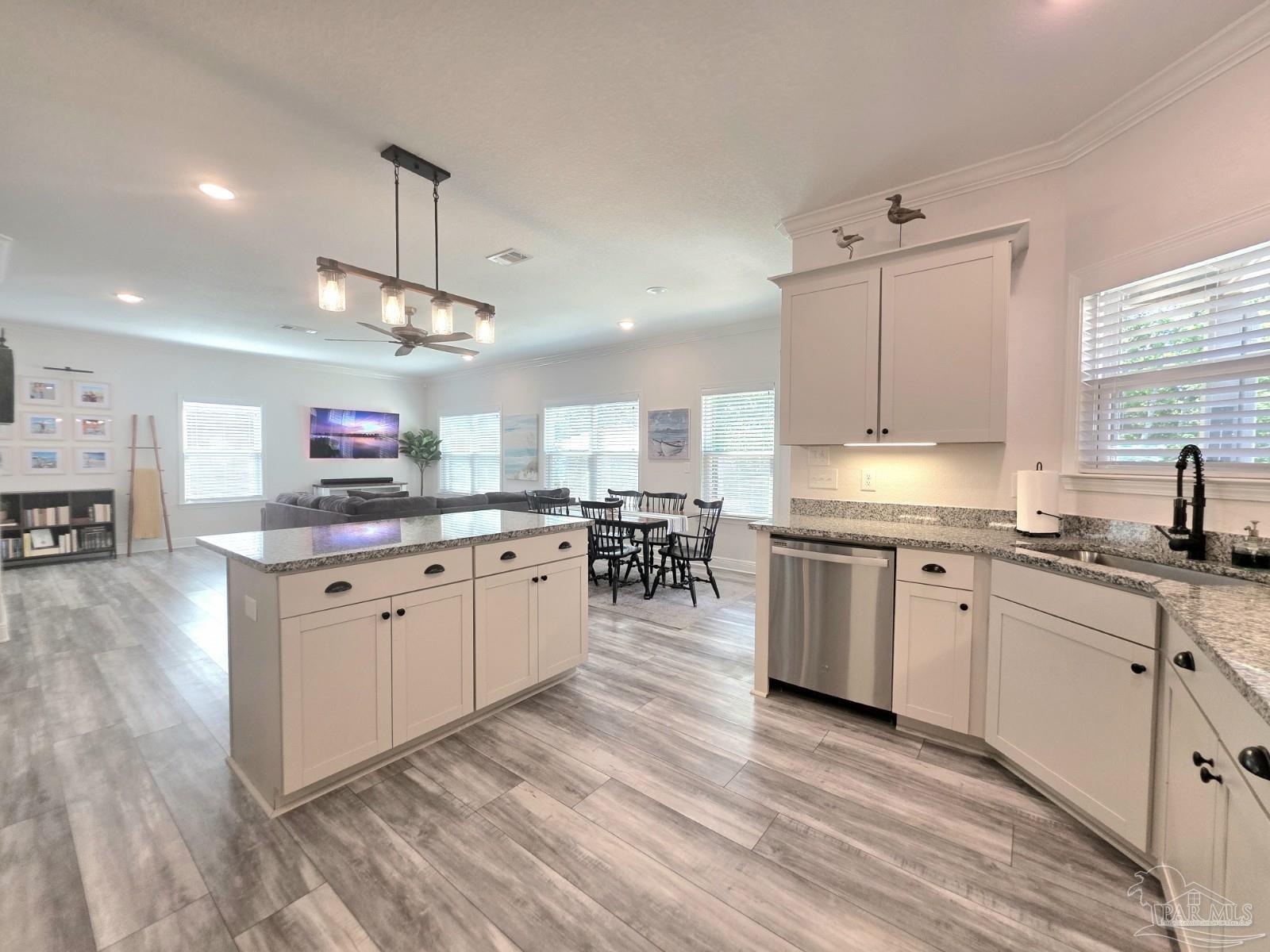 1307 Heron Inlet Pensacola, FL 32506 - Photo 6 of 35 a large kitchen with granite countertop a stove top oven a sink a counter space and cabinets