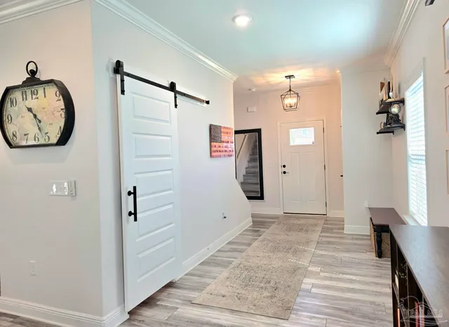 a view of a hallway with wooden floor and entryway