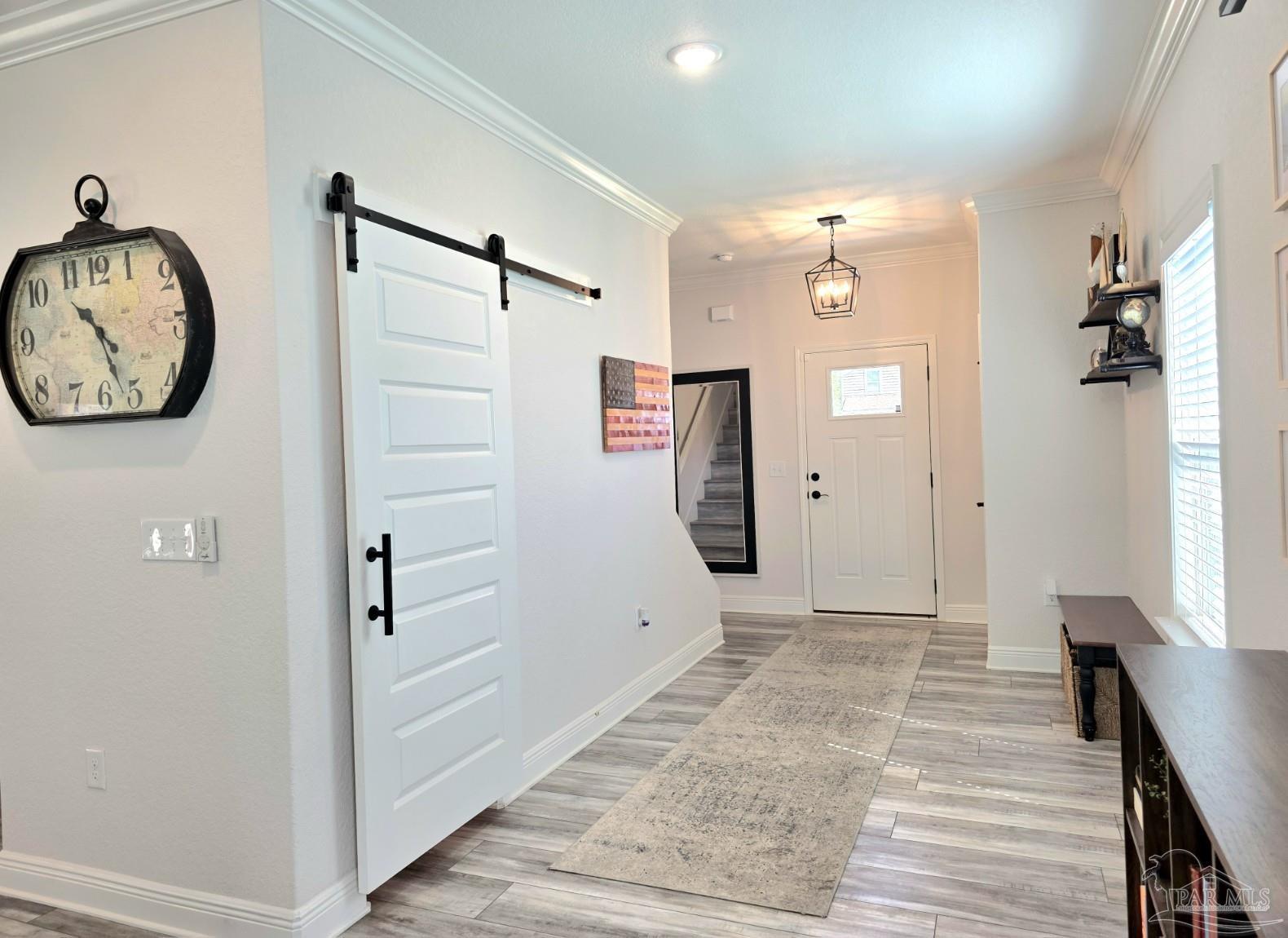 1307 Heron Inlet Pensacola, FL 32506 - Photo 7 of 35 a view of a hallway with wooden floor and entryway