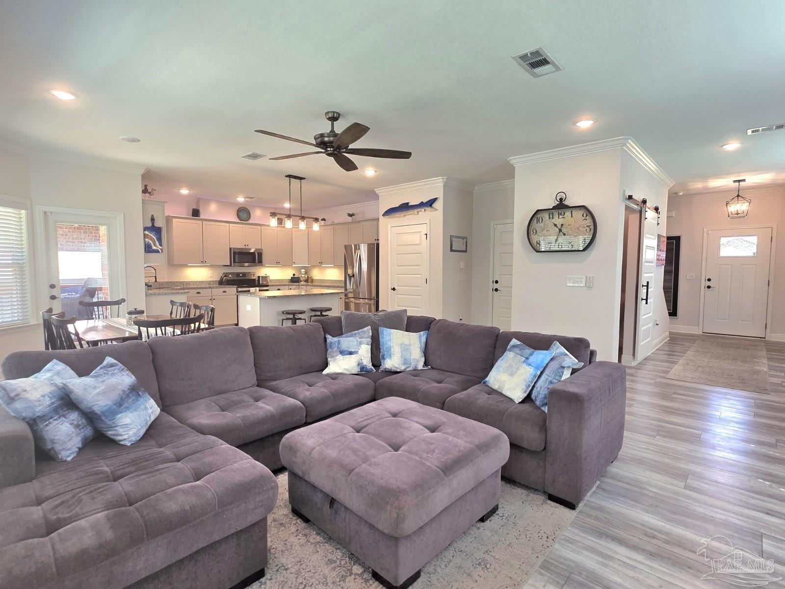 1307 Heron Inlet Pensacola, FL 32506 - Photo 8 of 35 a living room with furniture and kitchen view