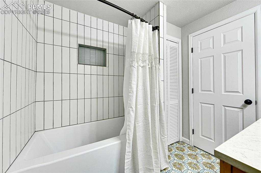 17350 Goshawk Road Colorado Springs, CO 80908 - Photo 30 of 50 a bathroom with a bathtub and shower