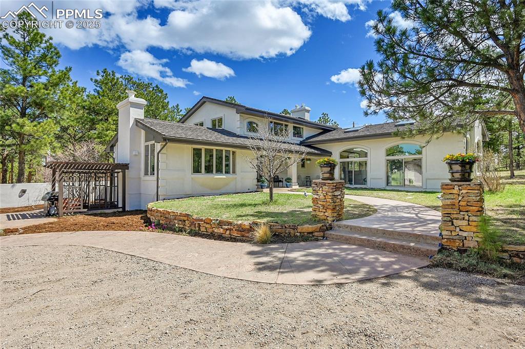 17350 Goshawk Road Colorado Springs, CO 80908 - Photo 3 of 50 a front view of a house with a yard