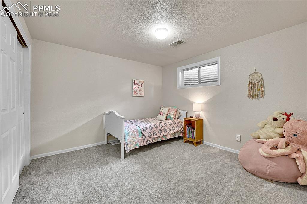 17350 Goshawk Road Colorado Springs, CO 80908 - Photo 31 of 50 a bedroom with a bed and a window