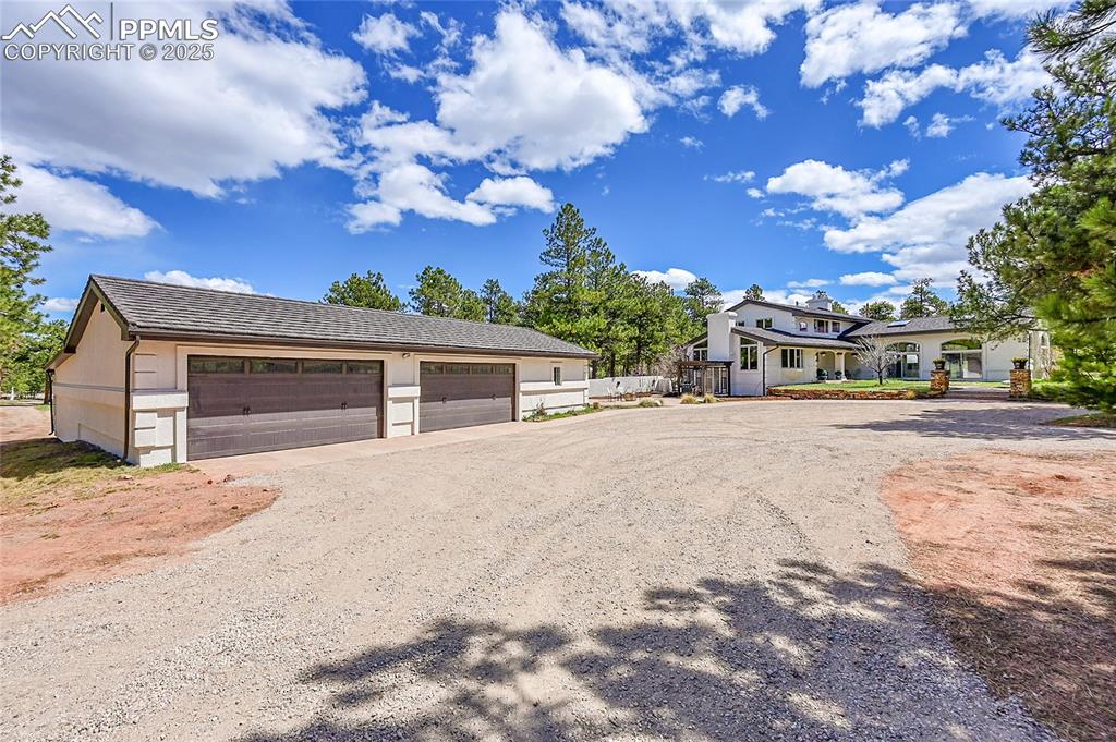 17350 Goshawk Road Colorado Springs, CO 80908 - Photo 35 of 50 a front view of a house with a yard and garage