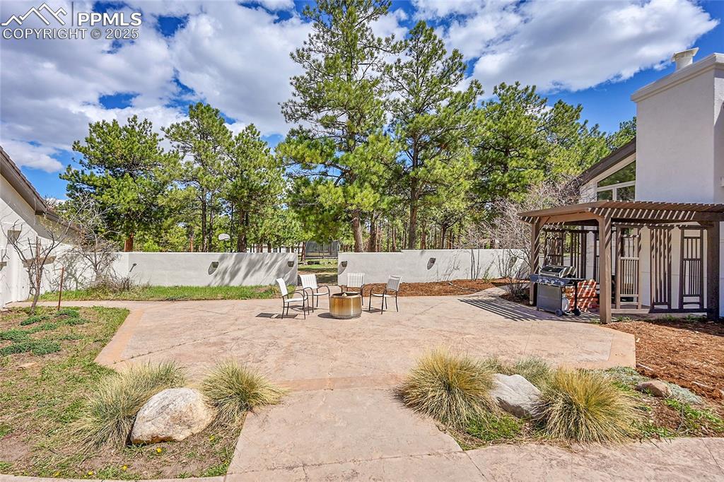 17350 Goshawk Road Colorado Springs, CO 80908 - Photo 36 of 50 a view of backyard with a sitting area and slide