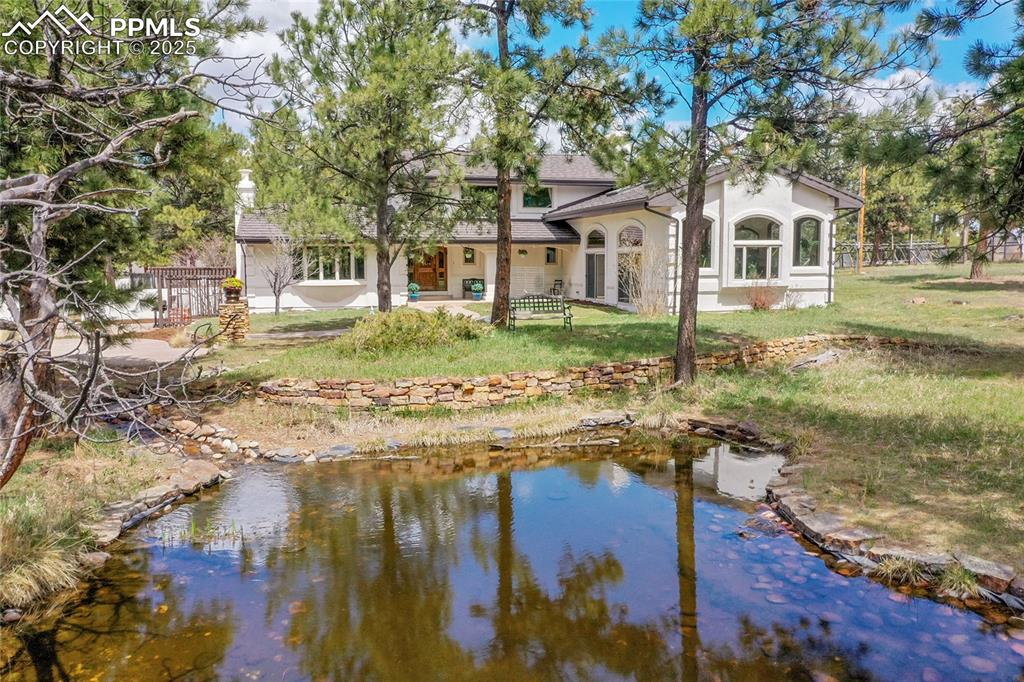 17350 Goshawk Road Colorado Springs, CO 80908 - Photo 39 of 50 a front view of a house with a yard