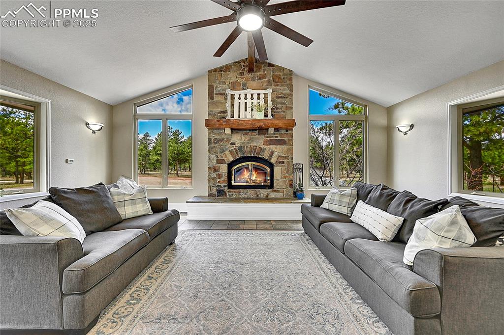 17350 Goshawk Road Colorado Springs, CO 80908 - Photo 8 of 50 a living room with furniture and a fireplace