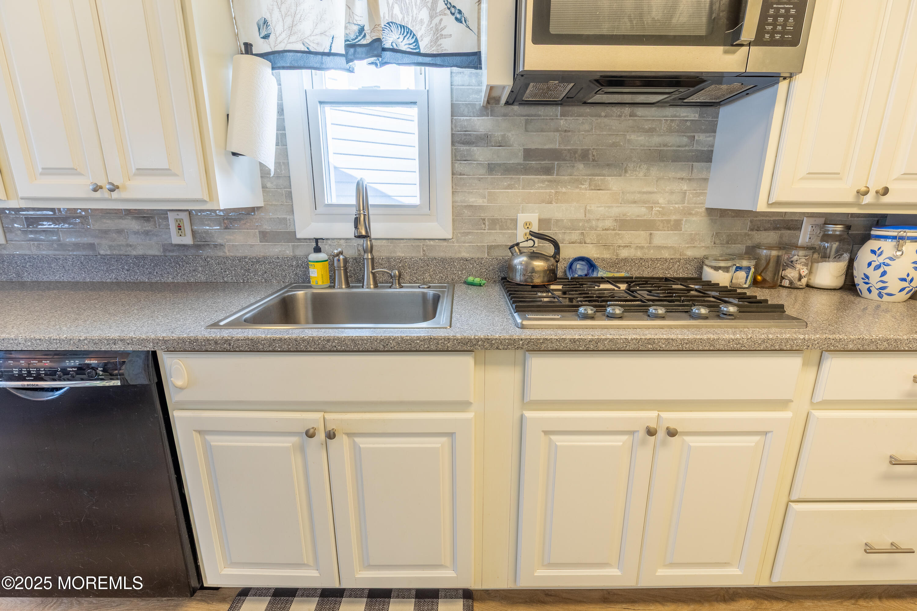121 L Street Seaside Park, NJ 08752 - Photo 11 of 37 a kitchen with granite countertop a sink a stove and cabinets
