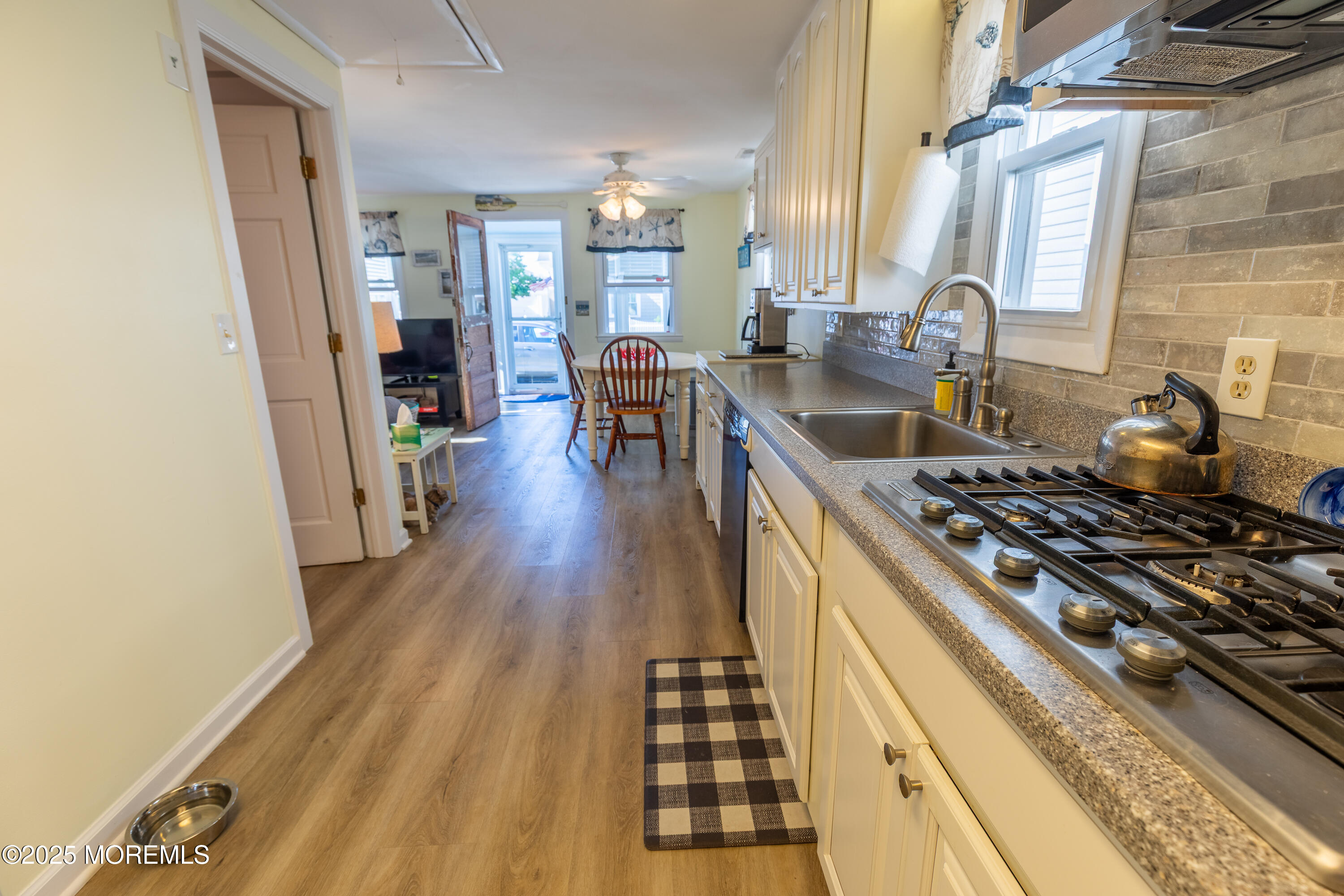 121 L Street Seaside Park, NJ 08752 - Photo 12 of 37 a kitchen with sink stove and cabinets