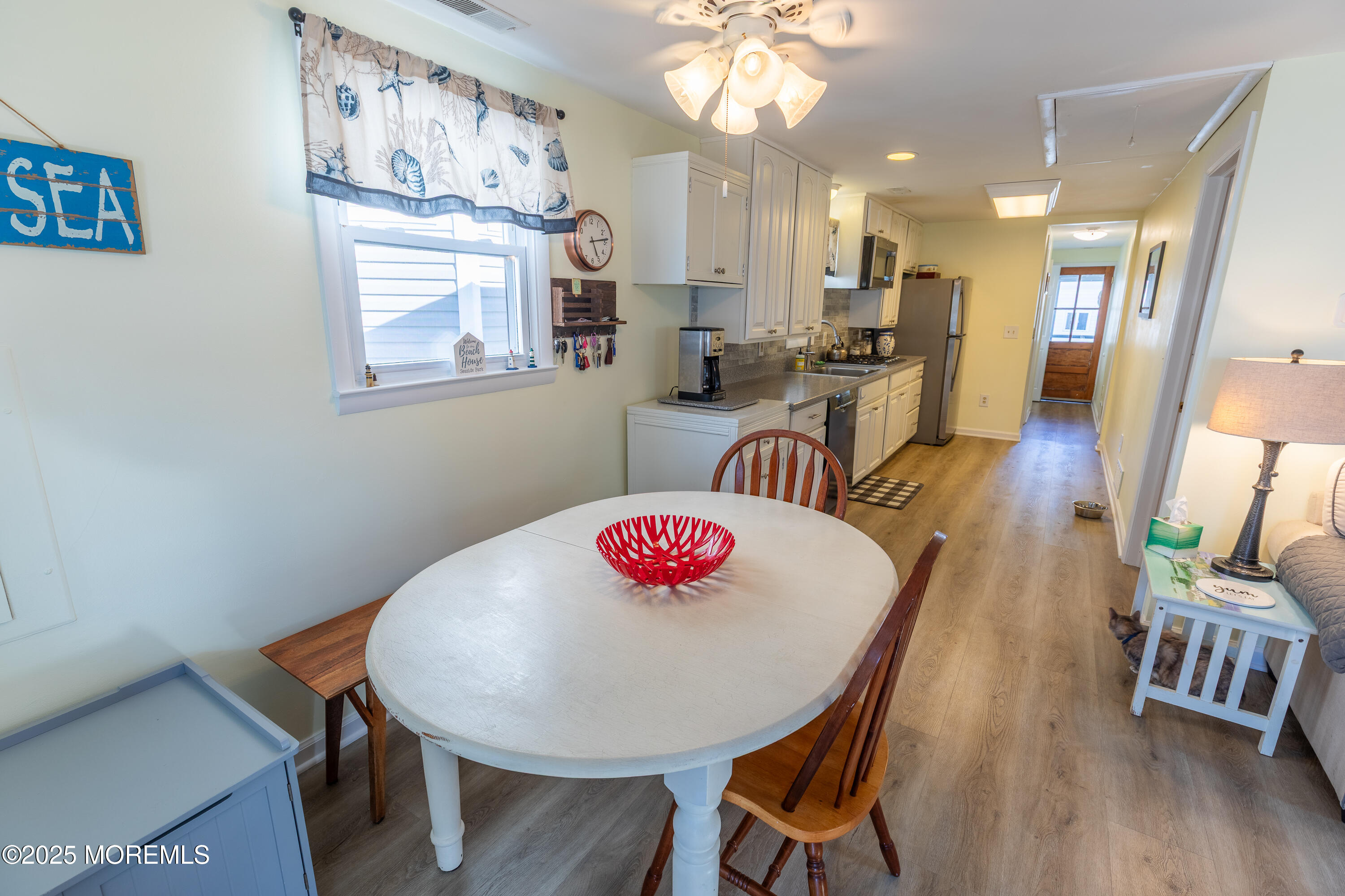 121 L Street Seaside Park, NJ 08752 - Photo 13 of 37 a dinning room and chandelier with wooden floor