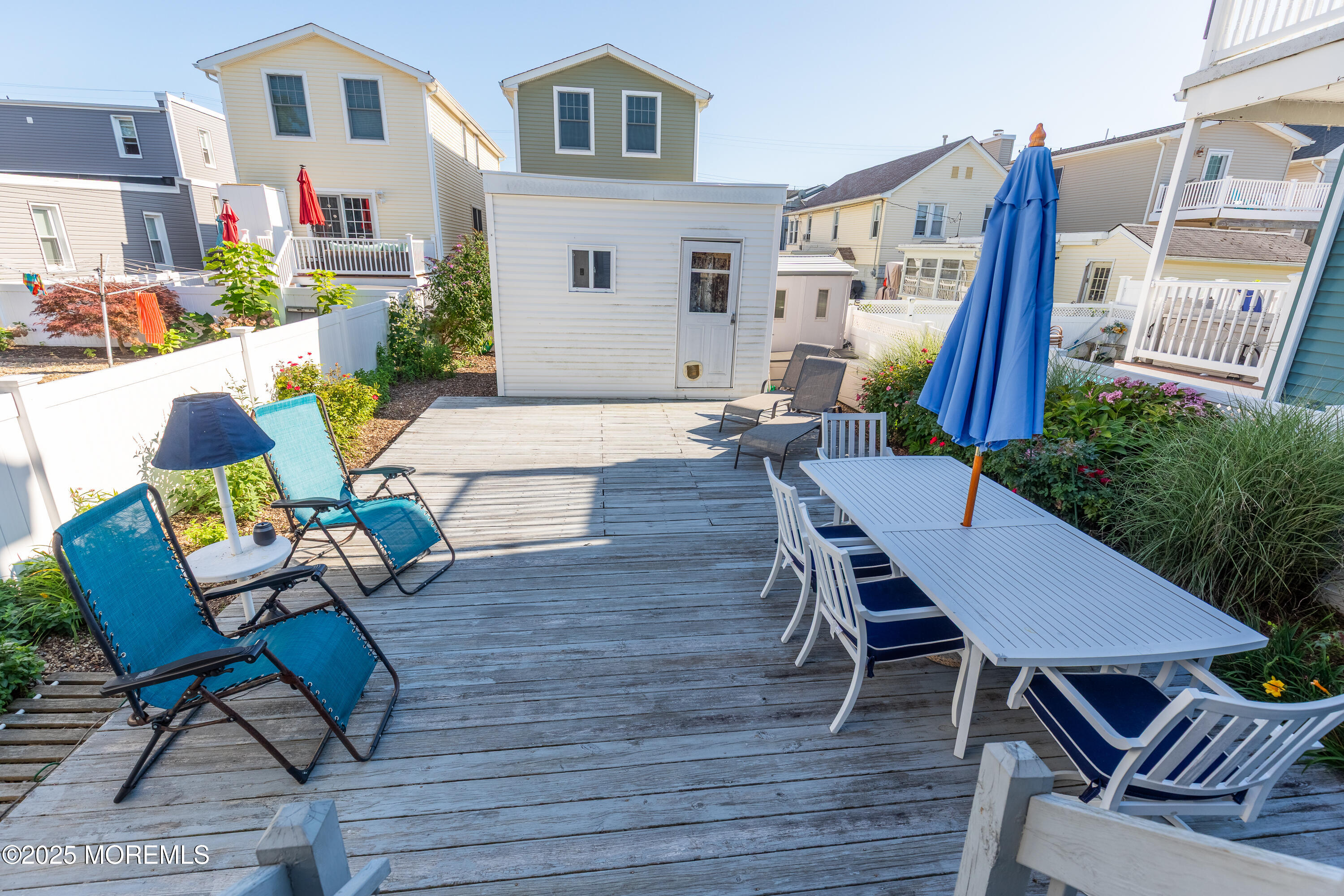 121 L Street Seaside Park, NJ 08752 - Photo 21 of 37 a view of a patio with couches table and chairs and potted plants