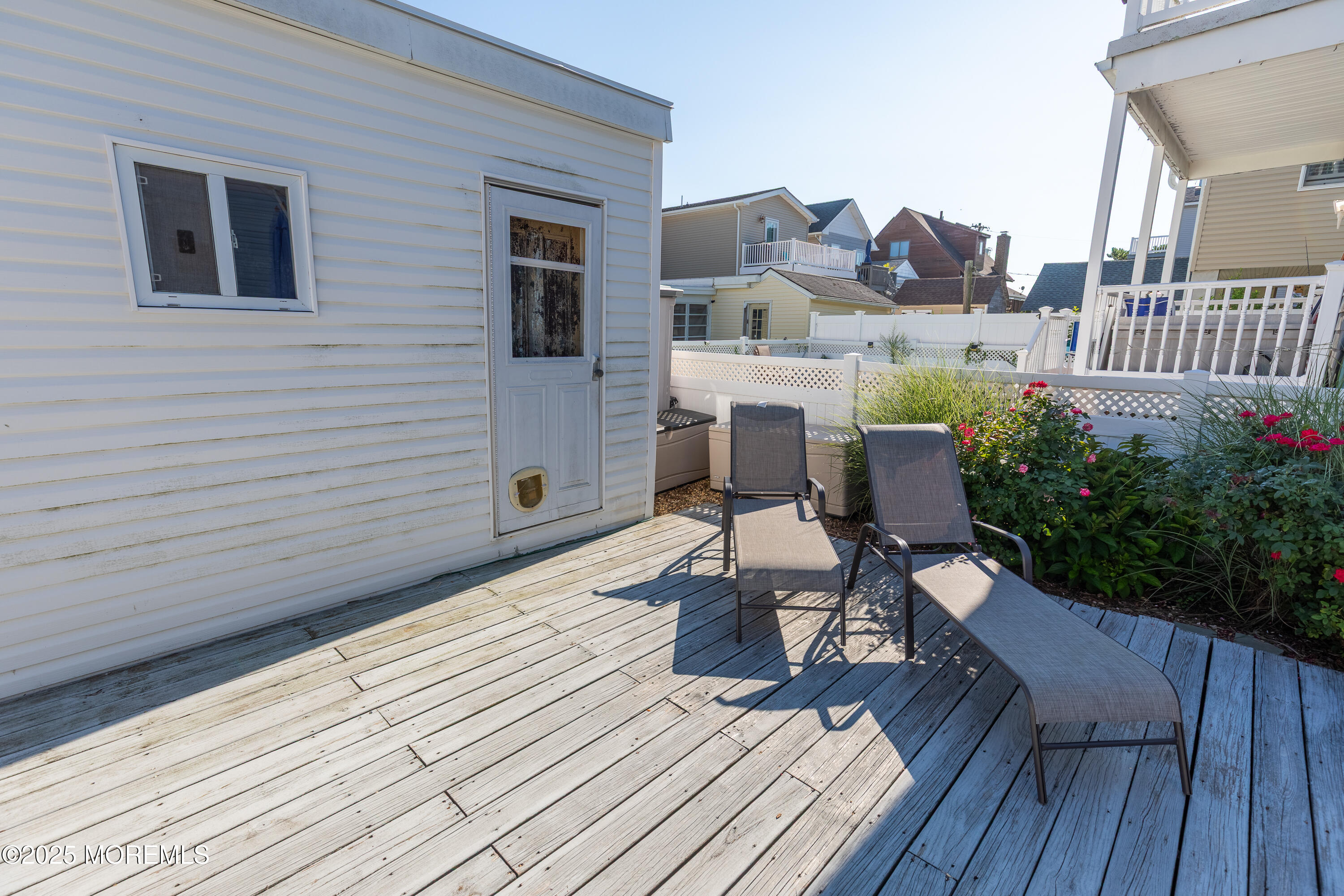 121 L Street Seaside Park, NJ 08752 - Photo 25 of 37 a view of a roof deck with table and chairs potted plants with wooden floor