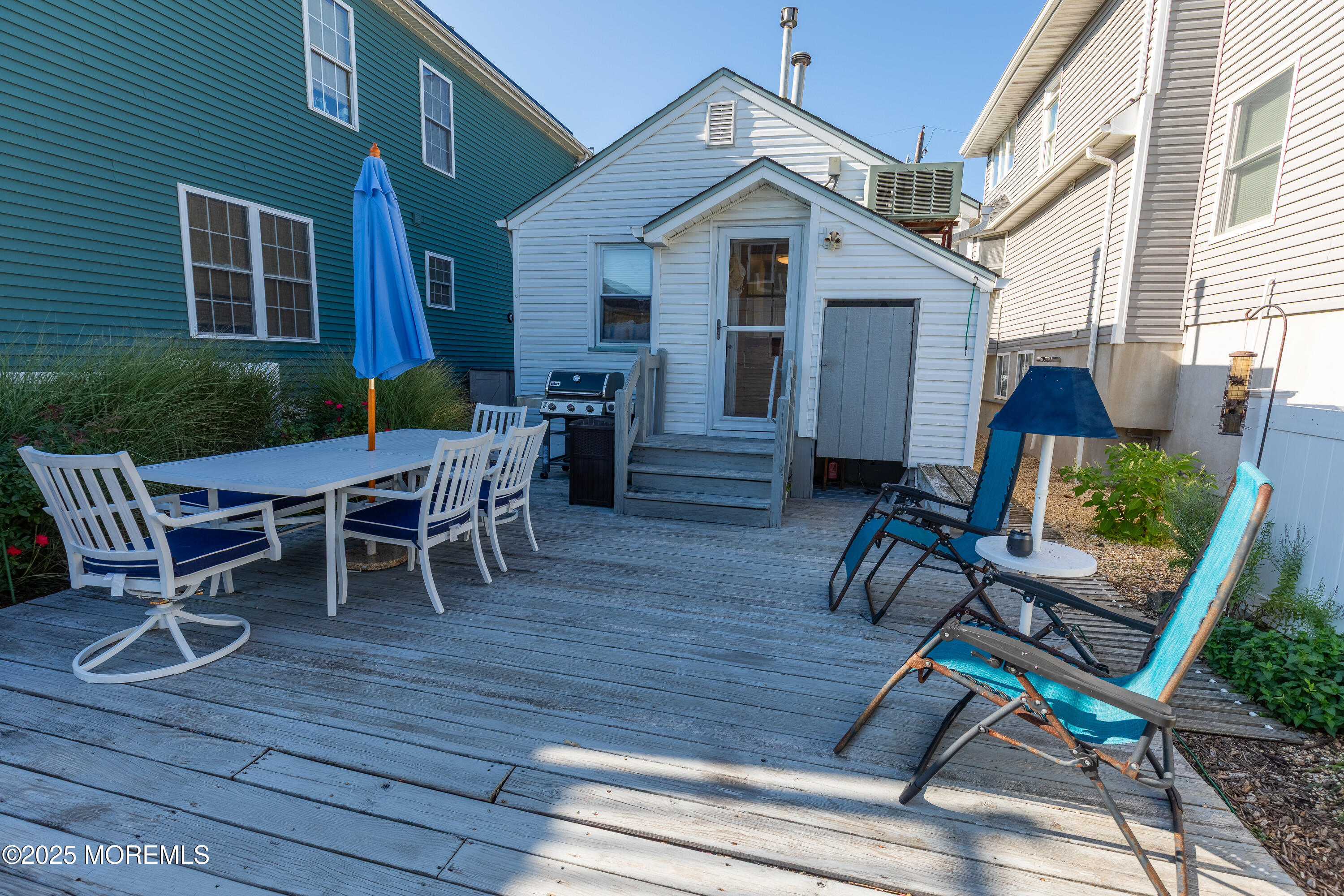 121 L Street Seaside Park, NJ 08752 - Photo 26 of 37 a view of a patio with table and chairs with wooden floor and fence