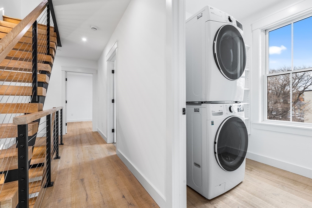 360 Athens Street, Unit 360 Boston, MA 02127 - Photo 15 of 27 a view of a hallway with washer and dryer