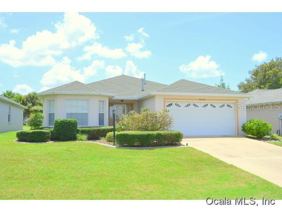 9656 Southwest 92nd Place Road Ocala, FL 34481 - Photo 1 of 1 a front view of a house with a yard and garage