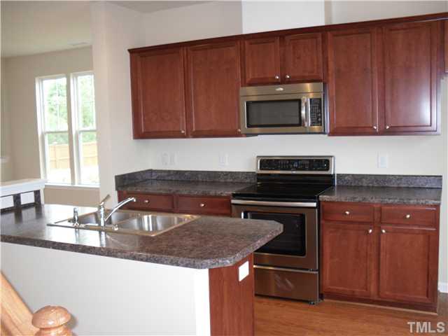 2966 Berkeley Street, Unit 25 Raleigh, NC 27612 - Photo 2 of 23 Beautiful kitchen with maple cabinets, stainless steel appliances and center island perfect for extra bar stool seating.