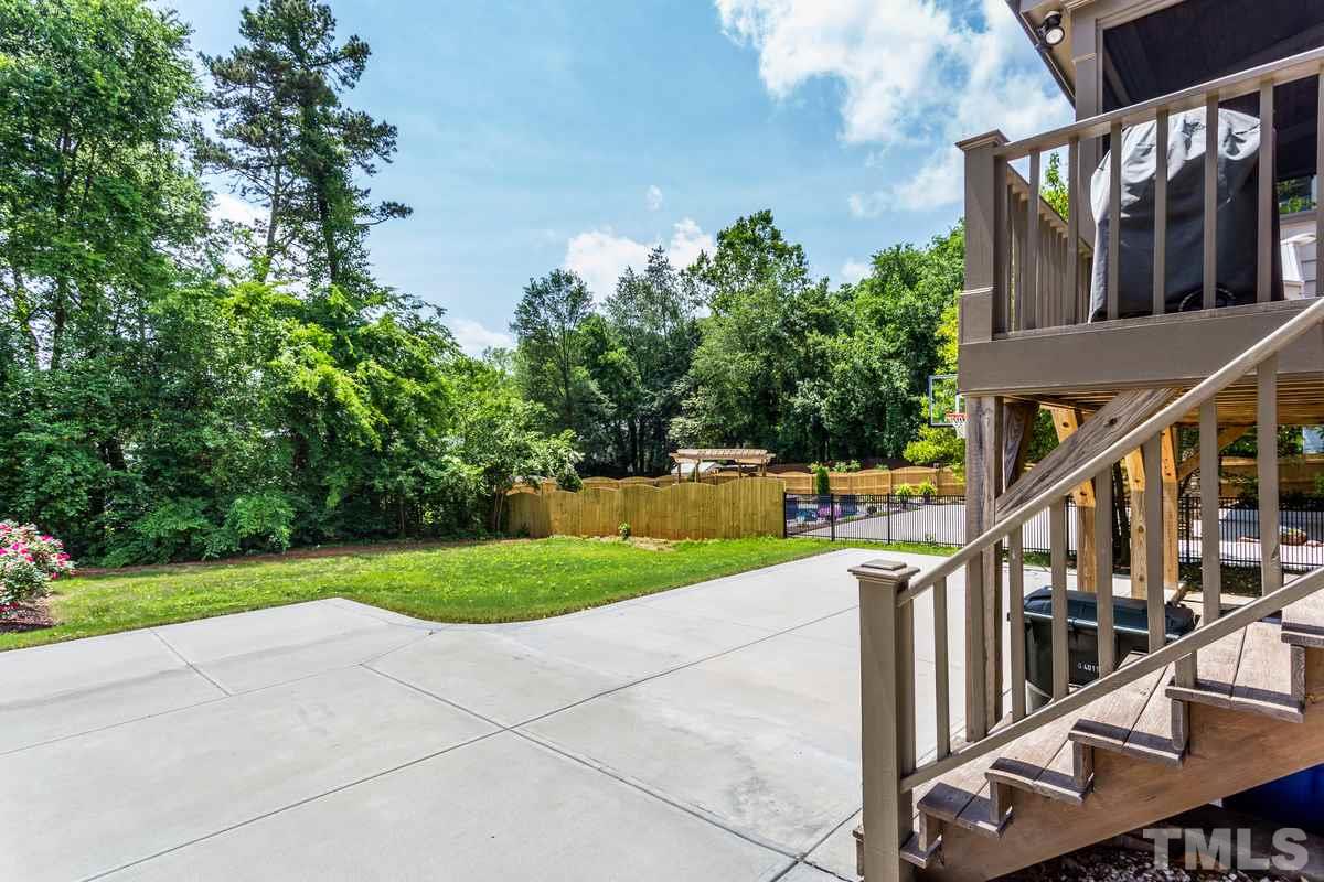 514 East Whitaker Mill Road Raleigh, NC 27608 - Photo 22 of 25 a view of a house with backyard and trees