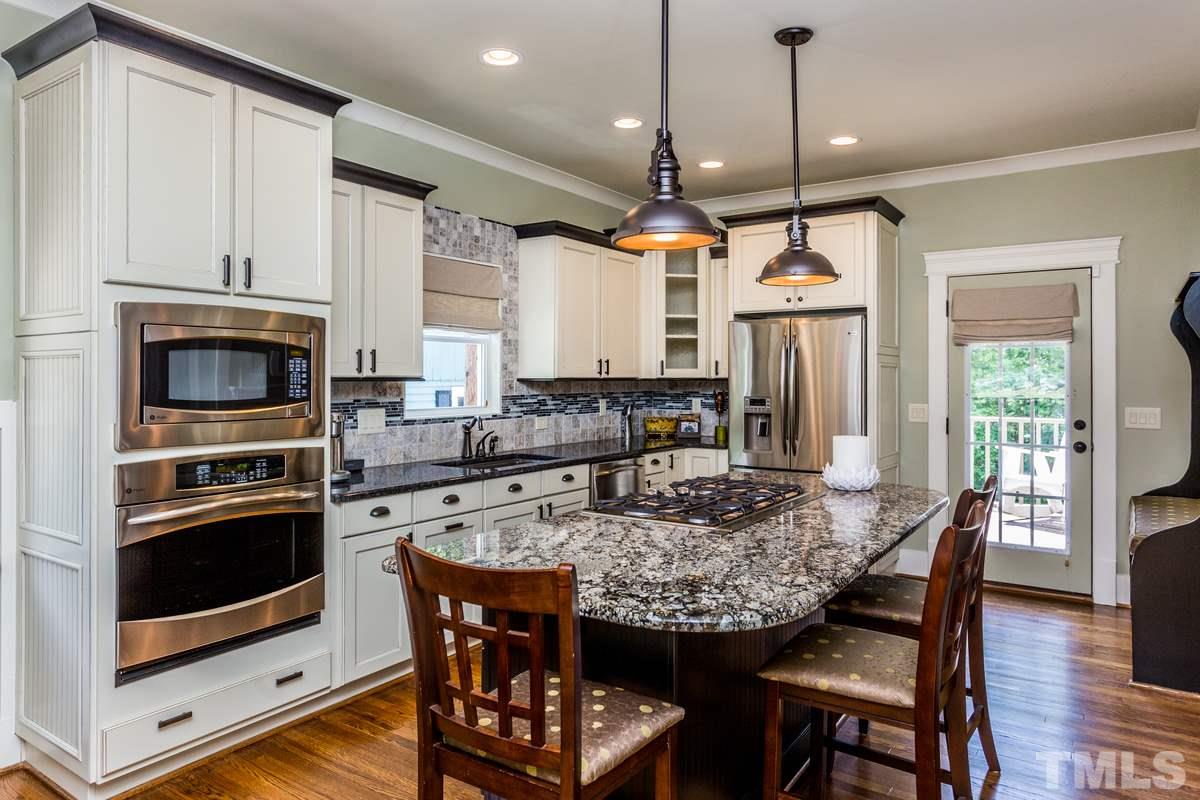 514 East Whitaker Mill Road Raleigh, NC 27608 - Photo 8 of 25 a kitchen with a stove a sink and a refrigerator