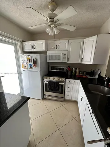 a kitchen with stainless steel appliances a stove a sink and a refrigerator