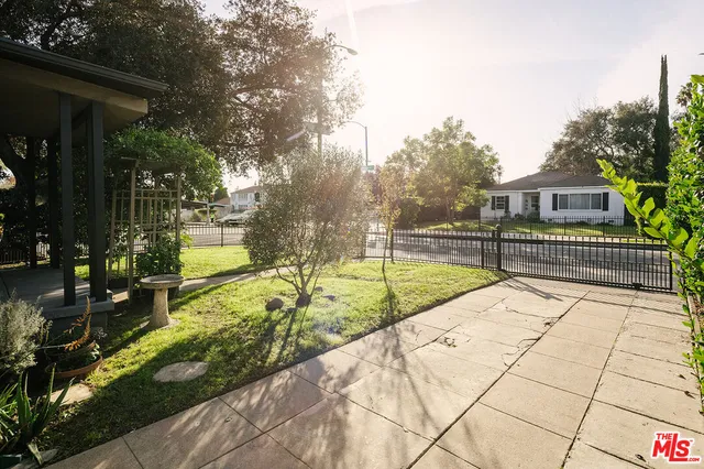a view of swimming pool with sitting area and garden