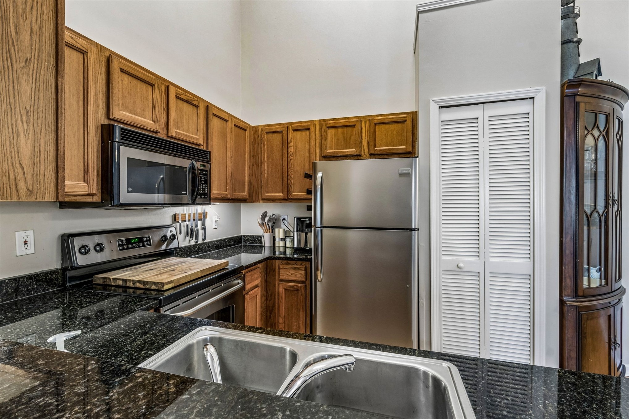 1601 Nectarine Street, Unit A6 Fernandina Beach, FL 32034 - Photo 16 of 40 a kitchen with stainless steel appliances granite countertop a refrigerator a stove and a sink with wooden floor